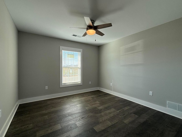 empty room featuring dark wood-type flooring and ceiling fan