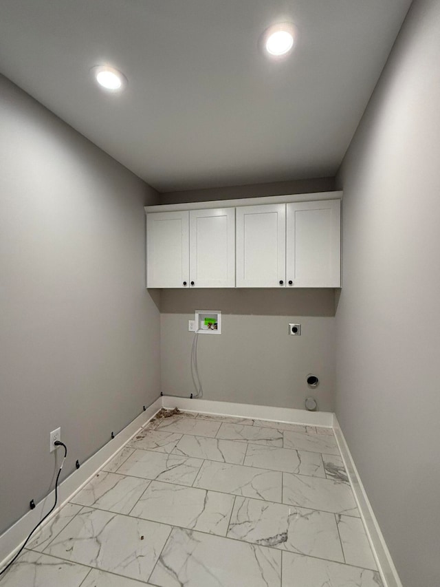 washroom featuring gas dryer hookup, washer hookup, cabinets, and hookup for an electric dryer