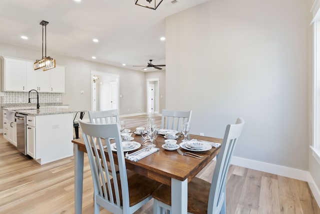 dining room featuring light wood-style flooring, baseboards, a ceiling fan, and recessed lighting