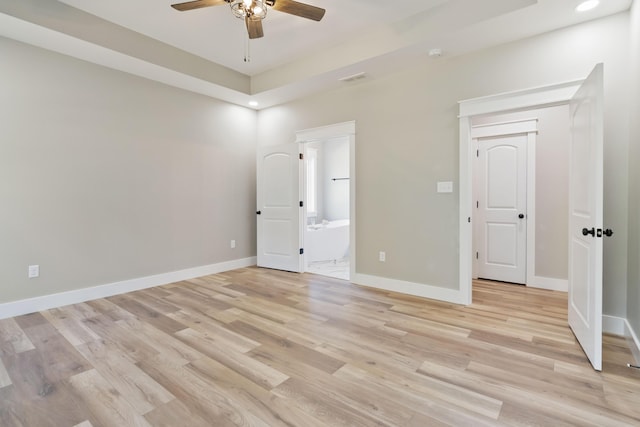 unfurnished bedroom with recessed lighting, ensuite bath, light wood-style flooring, and baseboards