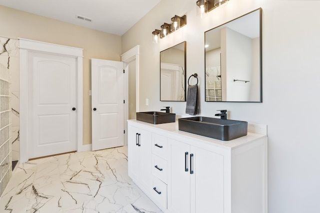 bathroom featuring double vanity, marble finish floor, visible vents, and a sink