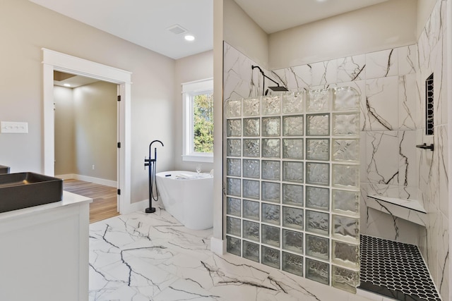 bathroom with a walk in shower, visible vents, baseboards, a freestanding bath, and marble finish floor