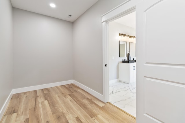 hall with marble finish floor, recessed lighting, and baseboards