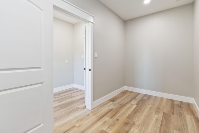 unfurnished room featuring recessed lighting, baseboards, and light wood finished floors