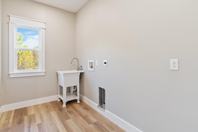 laundry room featuring washer hookup, light wood-style floors, electric dryer hookup, laundry area, and baseboards