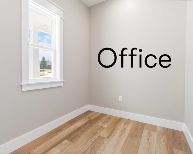 unfurnished room with light wood-style flooring and baseboards