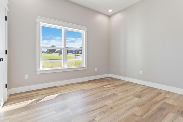 unfurnished room with recessed lighting, light wood-type flooring, and baseboards