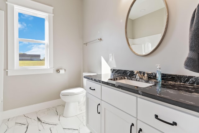 bathroom with marble finish floor, vanity, toilet, and baseboards