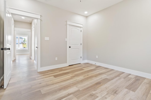 unfurnished room with light wood-style floors, baseboards, and recessed lighting