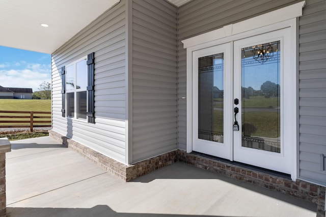 entrance to property with french doors and fence