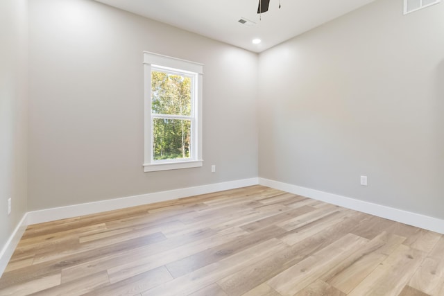 unfurnished room with ceiling fan, light wood-type flooring, and baseboards