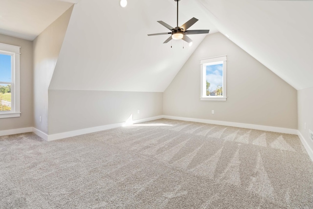 bonus room with vaulted ceiling, plenty of natural light, carpet flooring, and baseboards