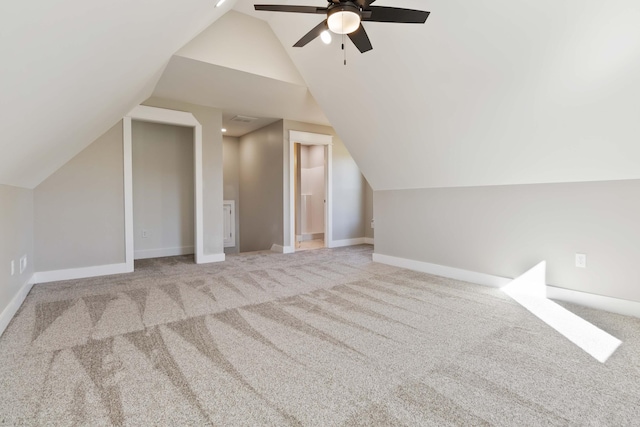 bonus room with lofted ceiling, carpet flooring, ceiling fan, and baseboards