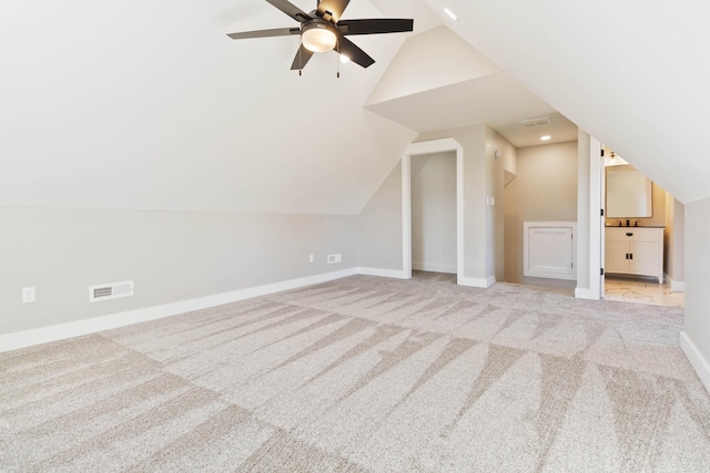 bonus room with lofted ceiling, visible vents, baseboards, and carpet flooring