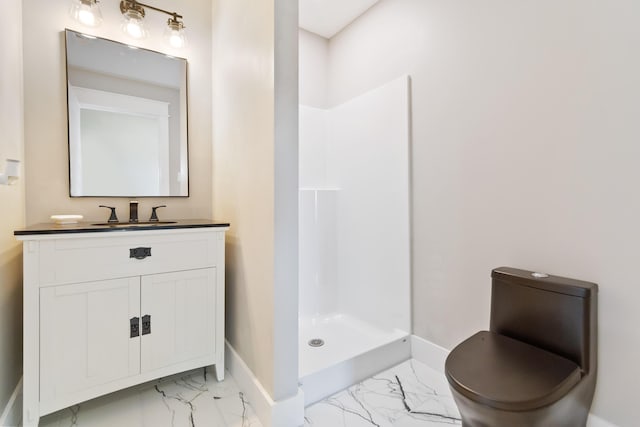 bathroom featuring marble finish floor, a stall shower, vanity, and baseboards