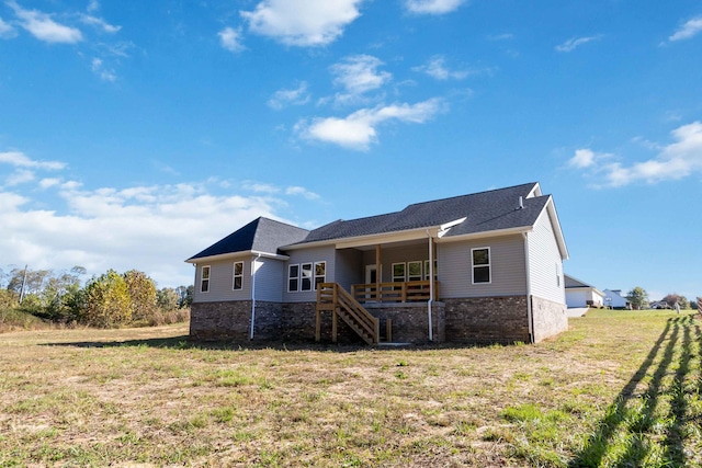 view of front of property with stairway and a front yard