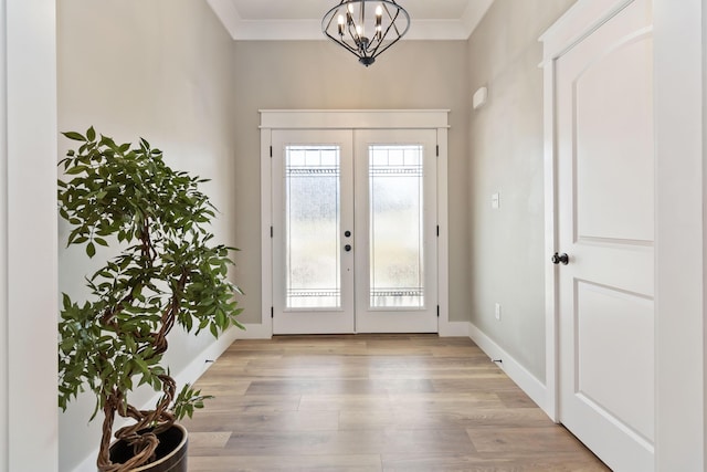 entryway featuring baseboards, french doors, light wood-style flooring, and crown molding