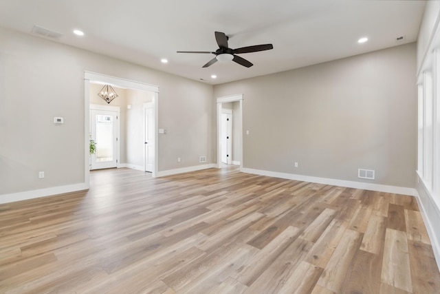 empty room featuring light wood-type flooring, baseboards, visible vents, and recessed lighting