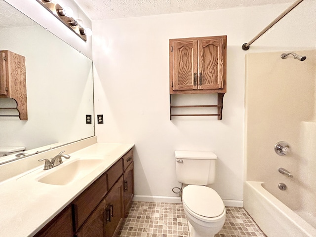 full bathroom with toilet, vanity, a textured ceiling, and tub / shower combination