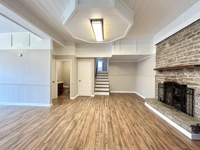 unfurnished living room with wood-type flooring and a fireplace