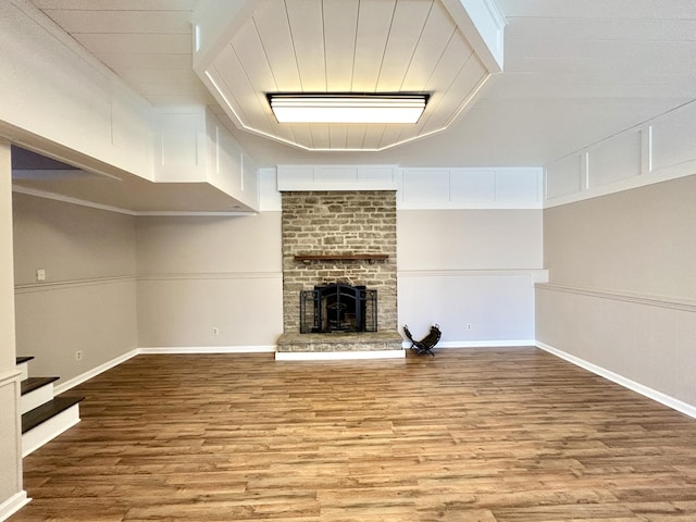 unfurnished living room featuring a high ceiling, light hardwood / wood-style flooring, and a fireplace