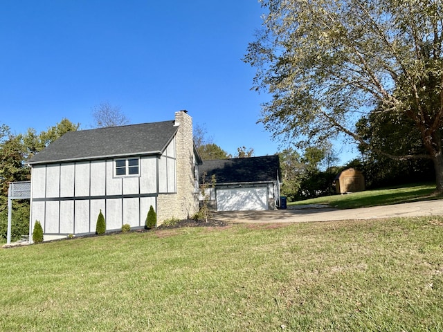 view of side of home featuring a lawn and a garage