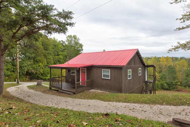 chalet / cabin with metal roof and a wooded view