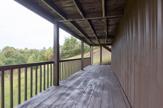 wooden terrace featuring a lawn