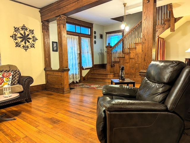 living room featuring wood-type flooring and ornate columns