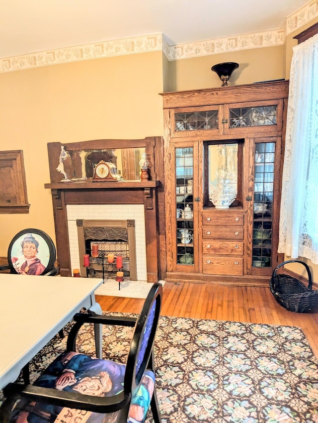 living room featuring wood-type flooring and a fireplace