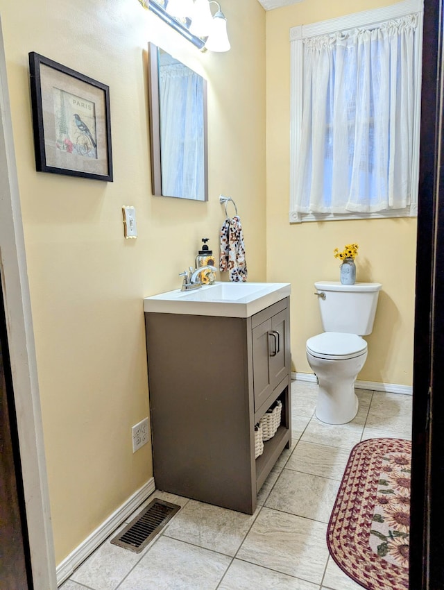 bathroom featuring toilet, vanity, and tile patterned floors