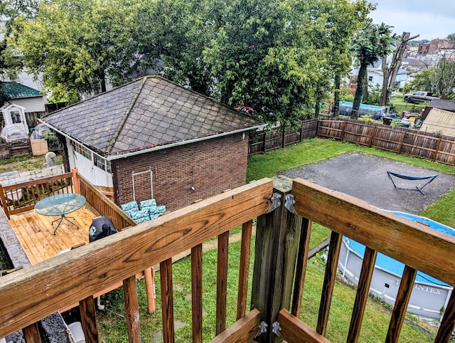 wooden deck featuring a yard