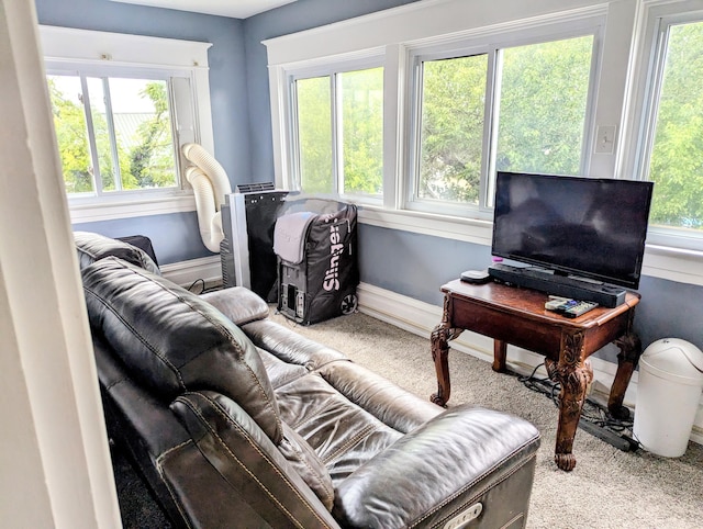 living room with plenty of natural light and light colored carpet