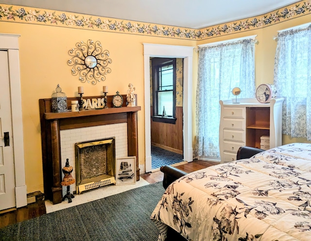 bedroom featuring a fireplace and wood-type flooring