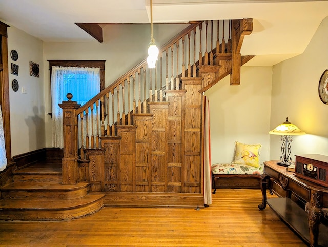 stairs featuring hardwood / wood-style floors