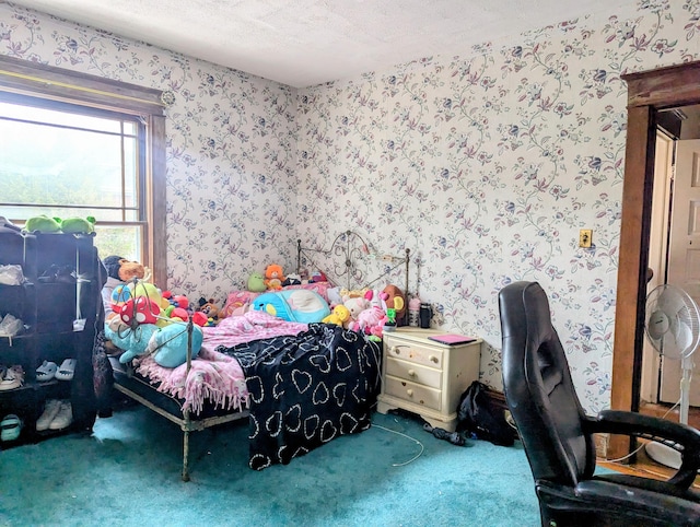 carpeted bedroom featuring a textured ceiling