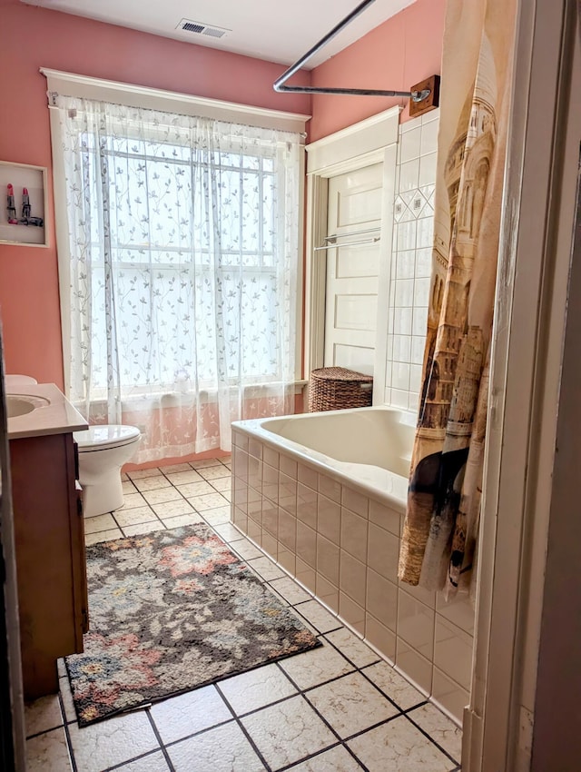 bathroom featuring toilet, tile patterned flooring, and vanity