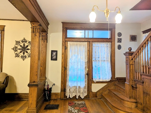 entryway with a chandelier and wood-type flooring