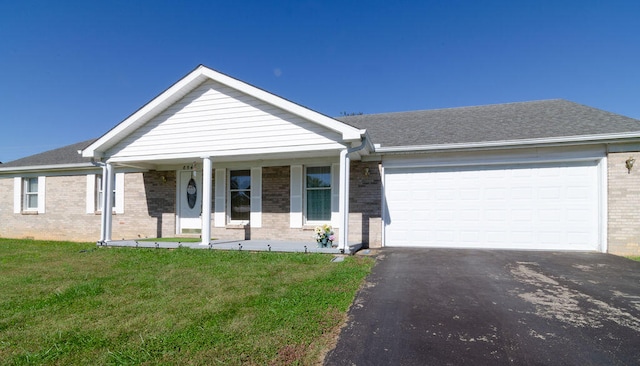 single story home featuring a garage, a porch, and a front lawn