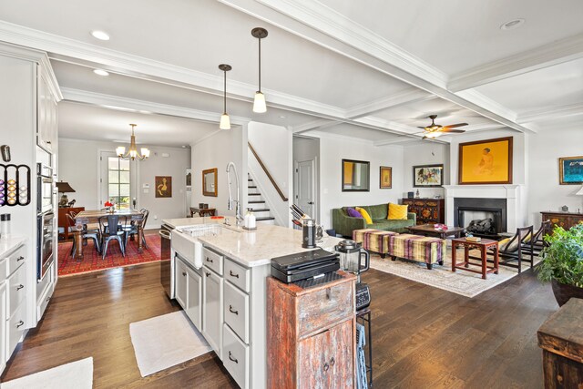 living room with coffered ceiling, ceiling fan, crown molding, hardwood / wood-style flooring, and beamed ceiling