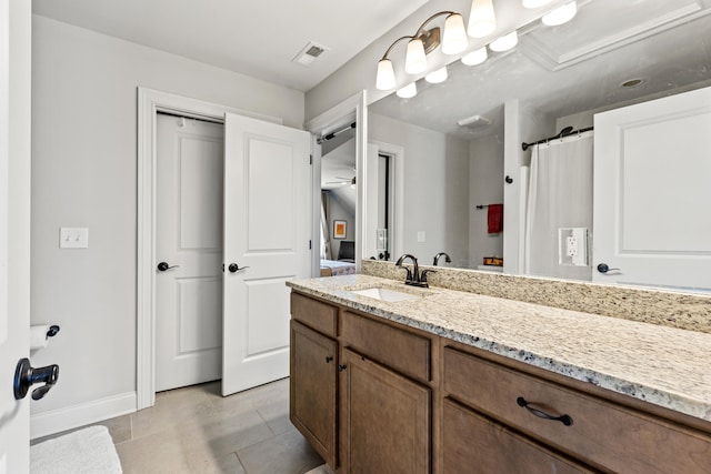 bathroom featuring tile patterned flooring and vanity