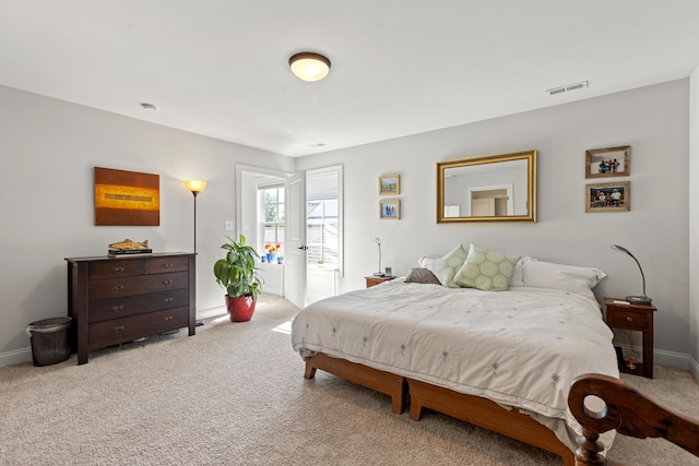 carpeted bedroom featuring access to exterior