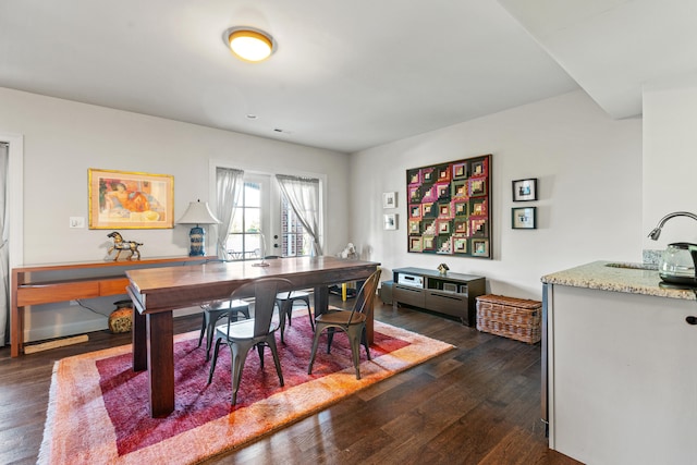 dining area featuring dark wood-type flooring and sink