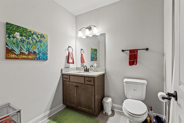 bathroom with tile patterned flooring, vanity, and toilet