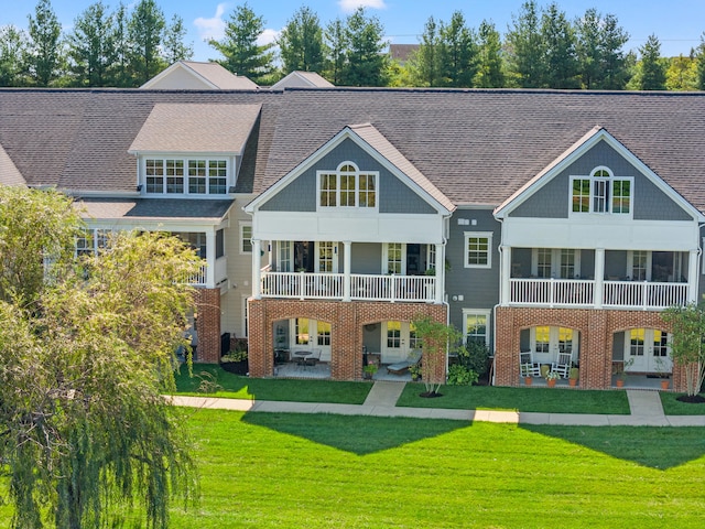 back of property featuring a lawn