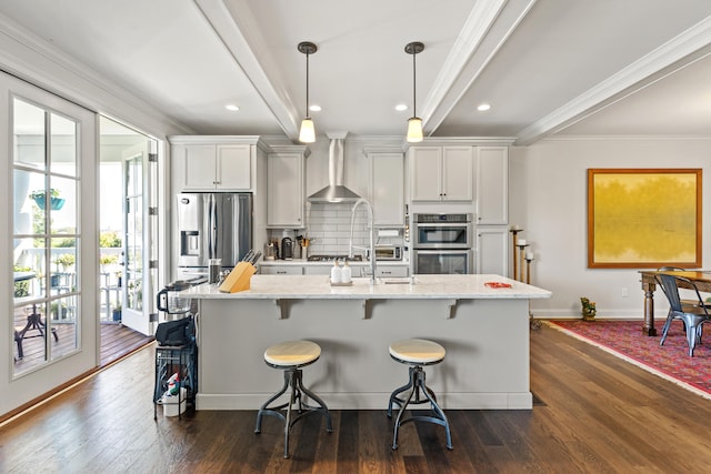 kitchen with pendant lighting, backsplash, wall chimney exhaust hood, a kitchen bar, and white cabinetry