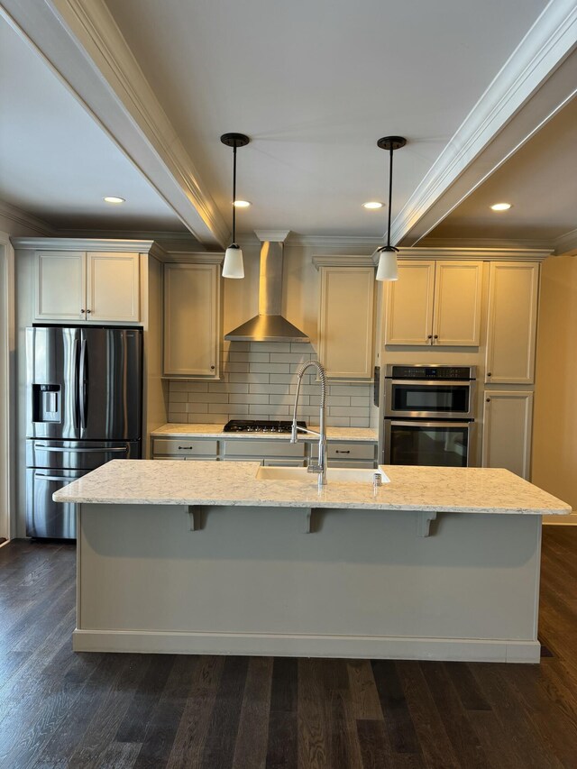 kitchen with pendant lighting, an island with sink, beam ceiling, light stone counters, and white cabinetry