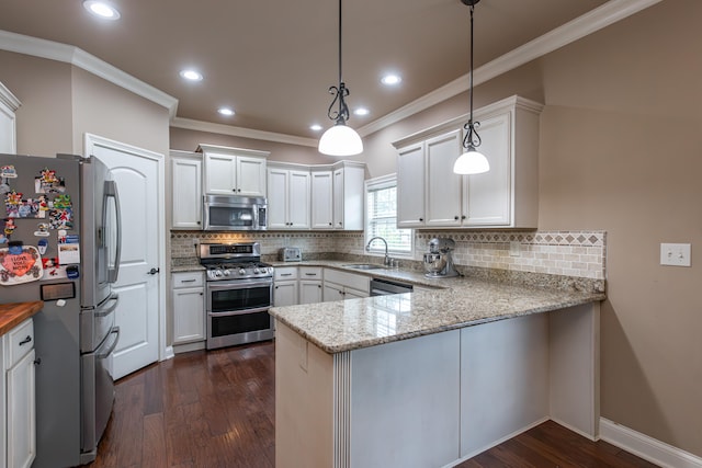 kitchen with white cabinets, kitchen peninsula, decorative light fixtures, stainless steel appliances, and dark hardwood / wood-style flooring