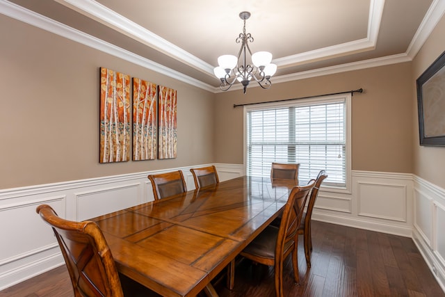 dining space with an inviting chandelier, crown molding, and dark hardwood / wood-style flooring