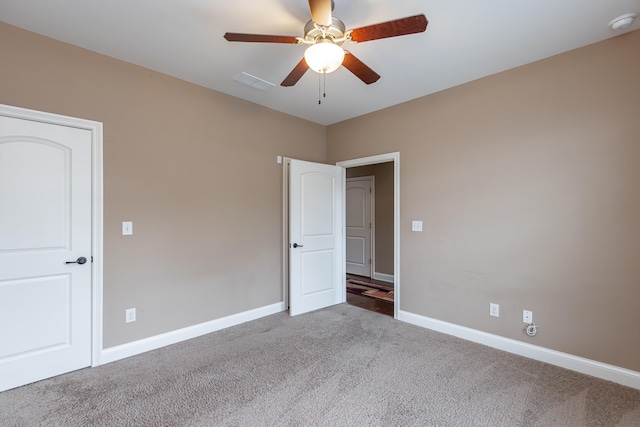 spare room featuring ceiling fan and carpet floors